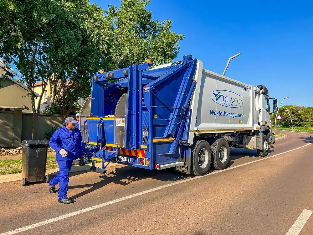Rua-Con collection crew loading a wheelie bin into a refuse compactor truck