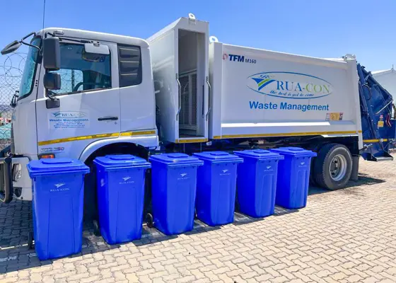 Rua-Con refuse compactor truck with blue wheelie bins