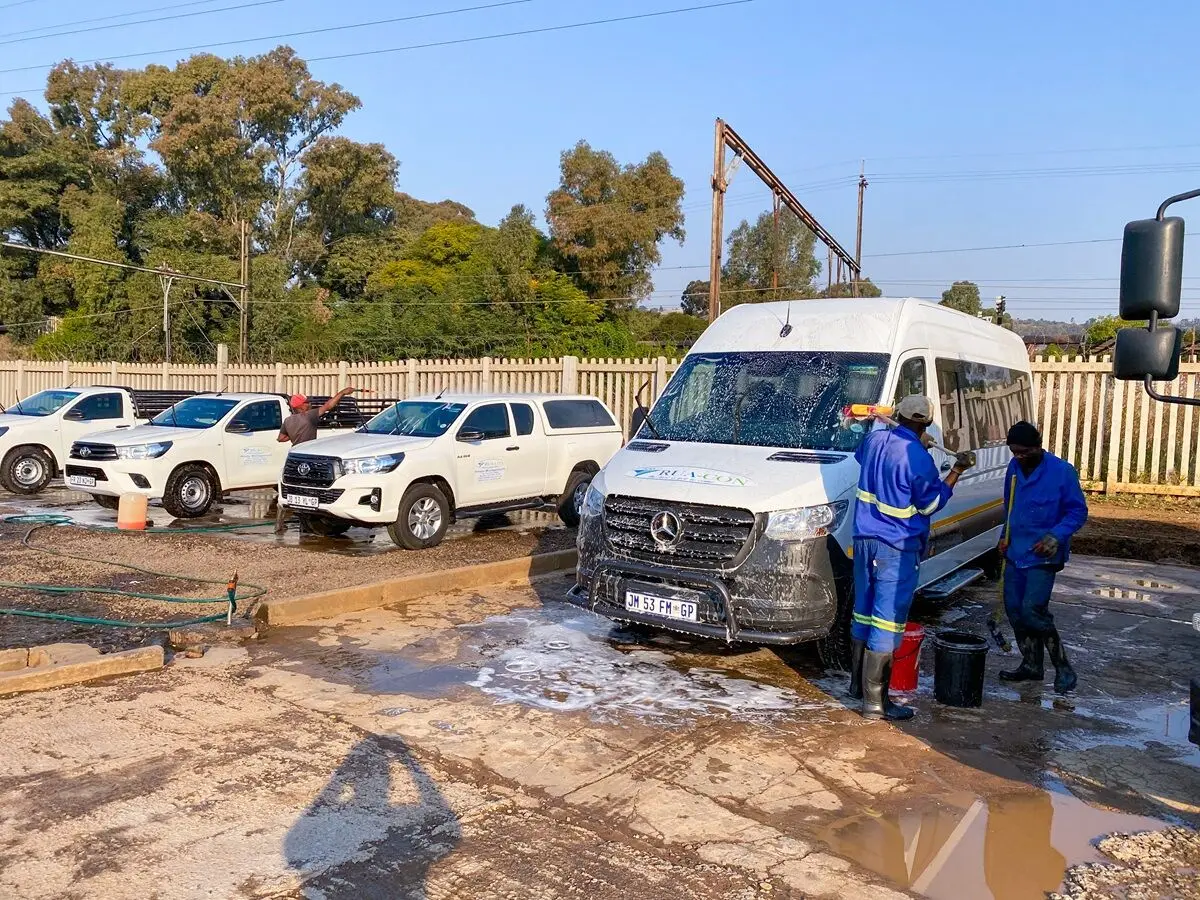 Rua-Con team members cleaning a vehicle at the depot